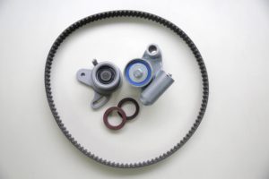 A disassembled cambelt in need of replacement, lying on a white countertop
