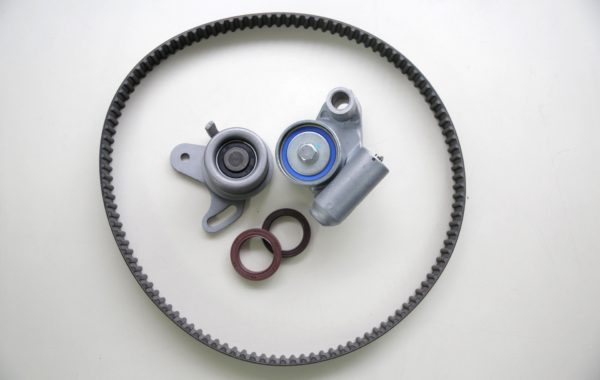 A disassembled cambelt in need of replacement, lying on a white countertop