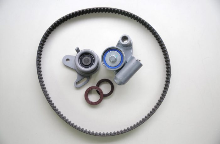 A disassembled cambelt in need of replacement, lying on a white countertop