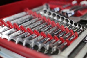 A set of combination wrenches laid out in size order.