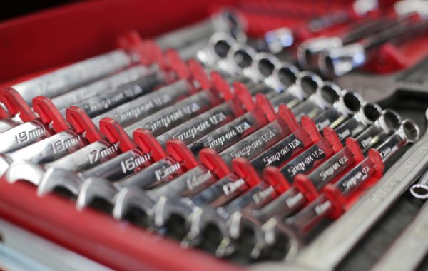 A set of combination wrenches laid out in size order.