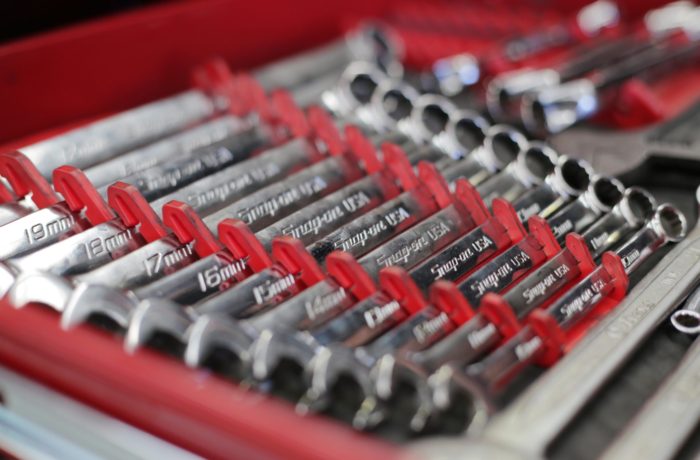 A set of combination wrenches laid out in size order.