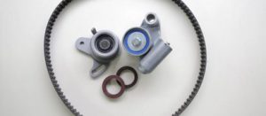 A disassembled cambelt in need of replacement, lying on a white countertop