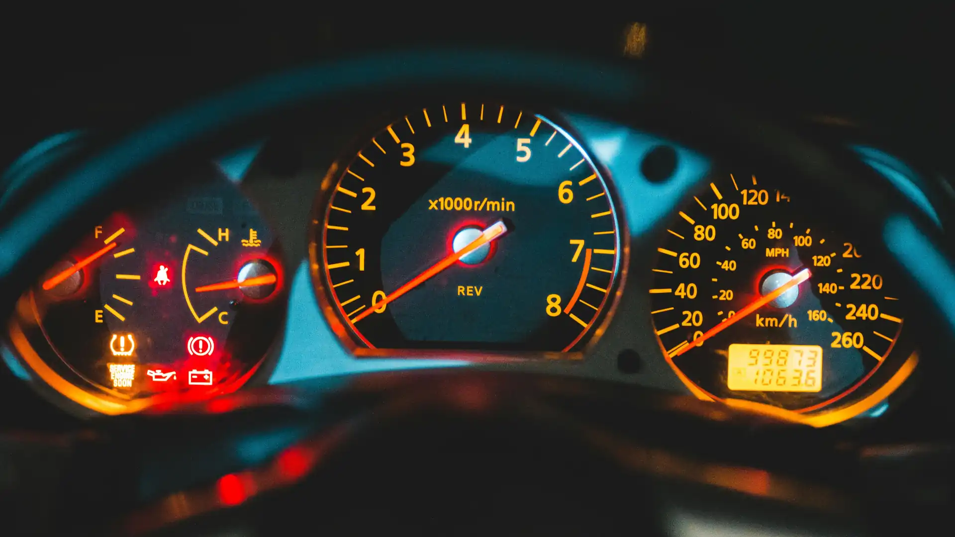 view of a car dashboard featuring illuminated guages